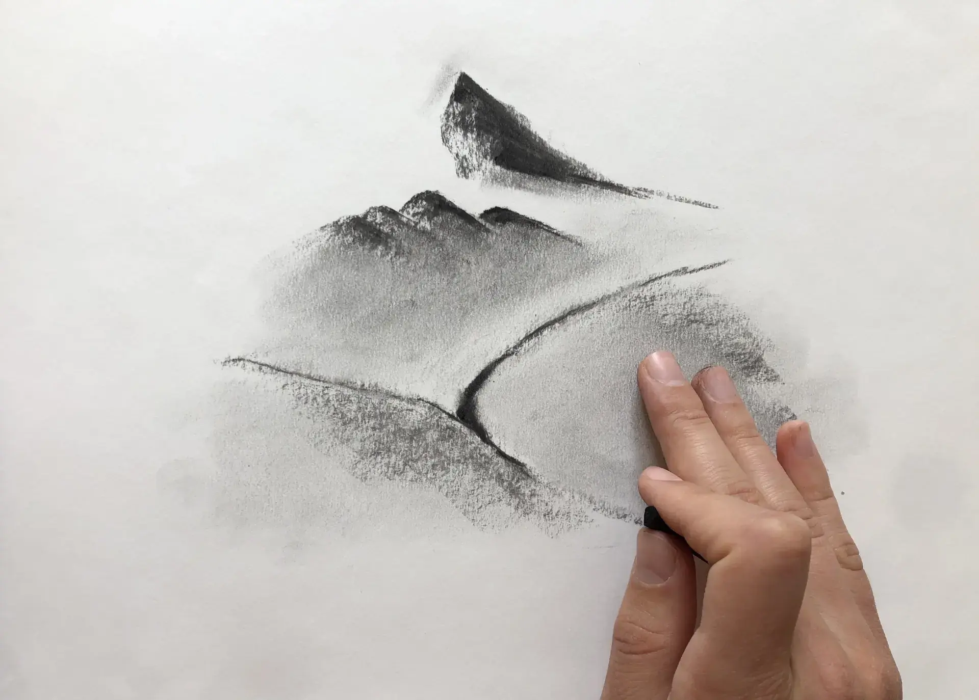 stomping on his charcoal landscape drawing