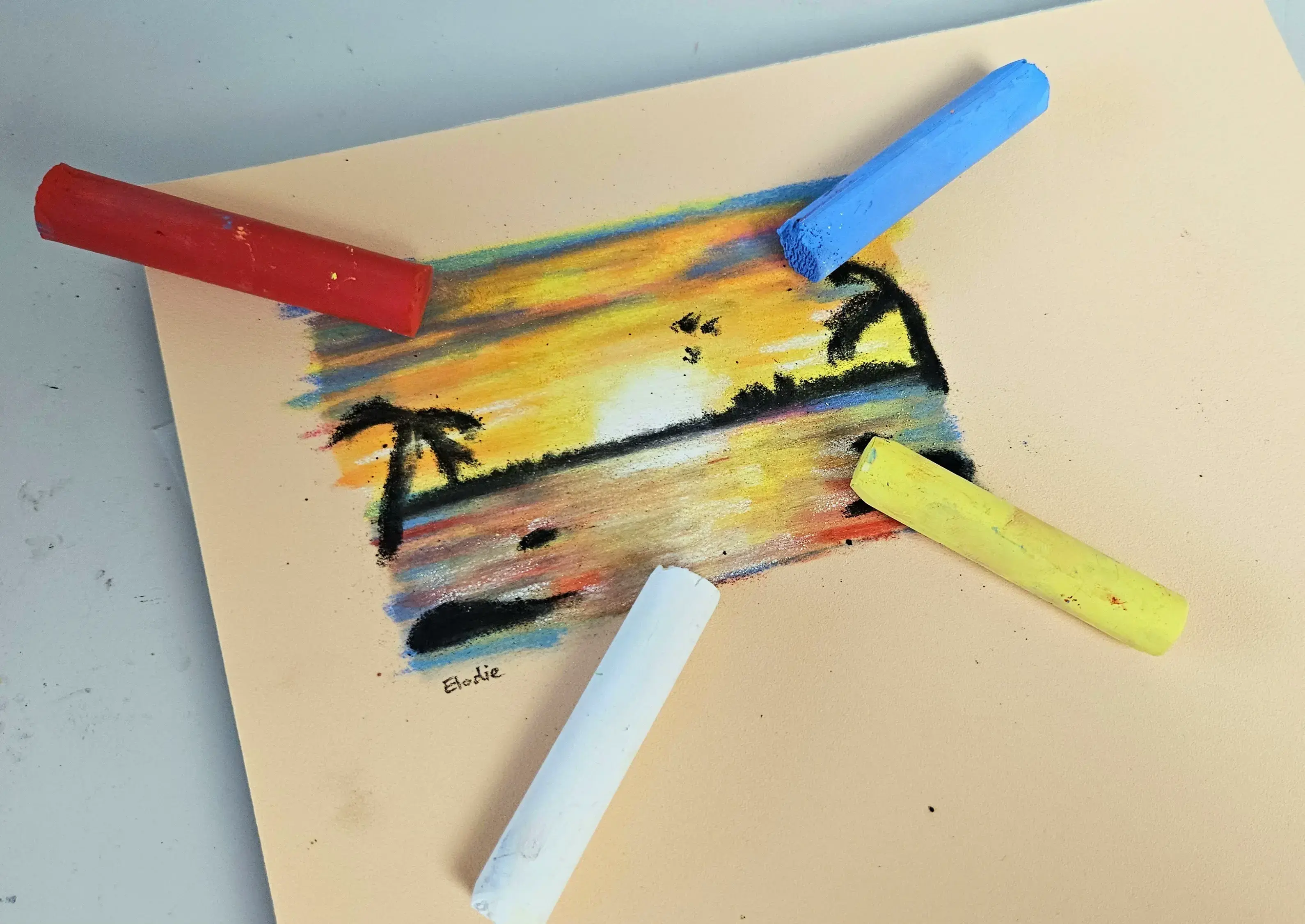 drawing of a sunset using pastels on colored paper